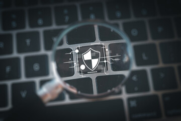 Online security and Cyber protection concept.,magnifying glass over a keyboard highlighting a...