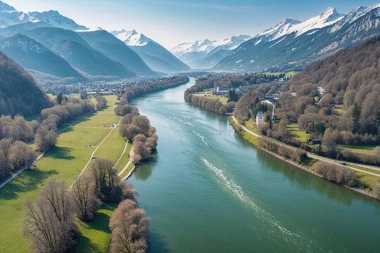 Panoramic Aerial View of the Serene Enns River Surrounded by Lush Mountainous Scenery on a Crisp Spring Day in Austria