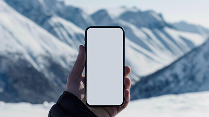 Hand holding smartphone against snowy mountain landscape, Mockup
