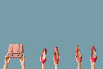 Women with stylish shoes and bag on blue background