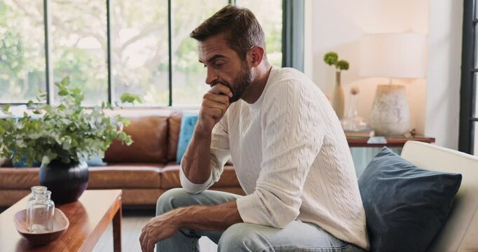 Stress, thinking and man with doubt in home for depression, reflection and worry for financial crisis. Anxiety, sad and person in living room with concern for fail, mistake or mental health challenge