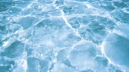 Obraz premium Cracked ice surface reflecting light, creating a cool abstract background for winter themes