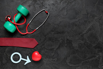 Stethoscope, heart, tie, dumbbell and male sign on black grunge background. Prostate cancer...
