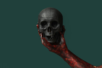 Hand of zombie with skull on green background. Halloween celebration