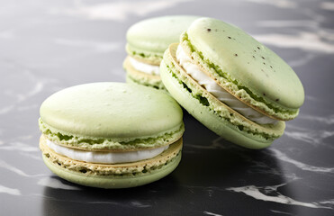 Green Macarons with Tan Filling on a White Marble Surface