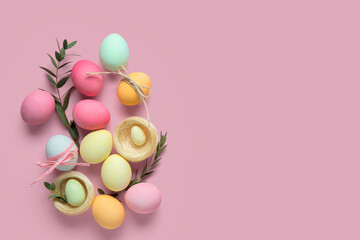 Composition with Easter eggs, decorative nests and green twigs on pink background