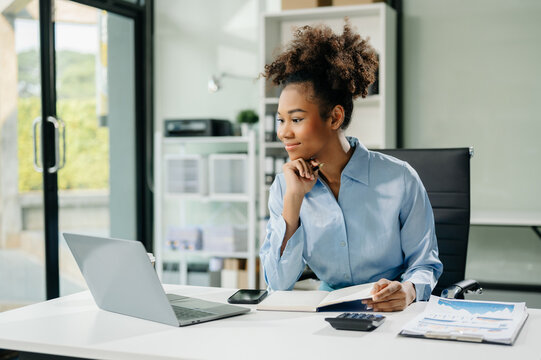 Confident business expert attractive smiling young woman typing laptop and holding digital tablet