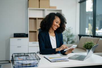Confident woman with a smile standing holding notepad and tablet