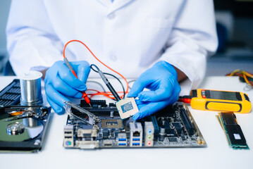 The technician repairing the motherboard in the lab with copy space. the concept of computer...