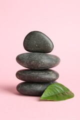 Stack of rocks on light pink background. Harmony and life balance
