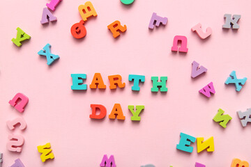 Text EARTH DAY with colorful letters on pink background