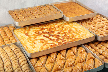 Mixed baklava varieties lined up on trays and tray water borek. Traditional Turkish dessert...