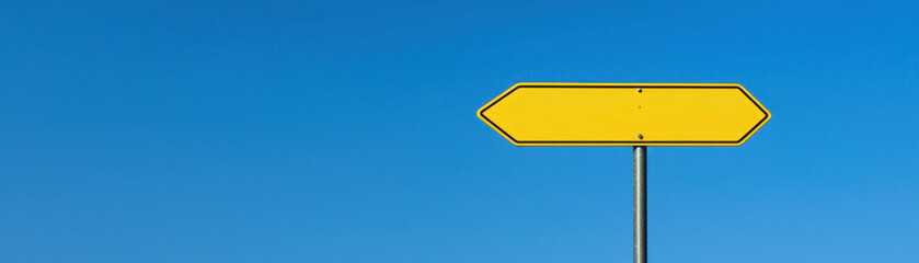 Entrepreneur thinking outside the box. Yellow road sign against clear blue sky, indicating direction