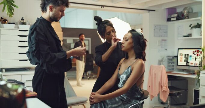Woman, model and makeup artist in studio for photoshoot, interview or fashion production. Behind the scenes, touch up and beautician in media agency with stylist, cosmetology and creative industry