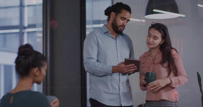 Holding tablet and mugs, colleagues discussing work in modern office