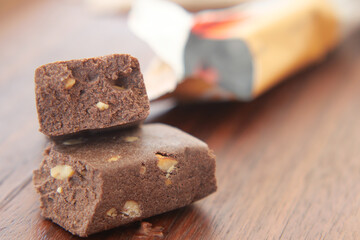 Delicious chocolate fudge with nuts displayed on wooden table