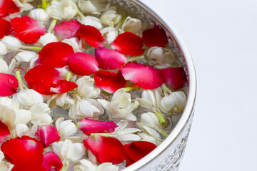 Water with jasmine flower with rose petal in silver bowl. Thai tradition, Songkran festival concept