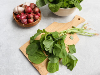 green spinach vegetables placed on the cutting board for food preparation. organic vegetable