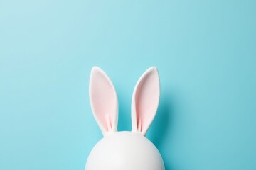 A Close-Up View of a Cute White Bunny Head with Pink Ears Against a Turquoise Background, Perfect for Spring and Easter Themes
