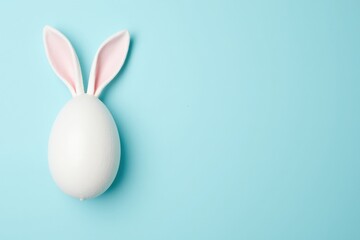 A Cute White Easter Egg with Pink Bunny Ears Set Against a Soft Blue Background, Perfect for Spring Celebrations and Festive Decor in Families and Communities