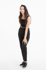 Portrait of full body asian beautiful woman with curly hair, wearing black tank top black long pants, model girl attractive confident standing smiling pose look at camera on white background in studio