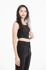 Fototapeta premium Portrait of asian beautiful woman with curly hair, wearing black tank top black long pants, model girl attractive confident cheerful standing smiling pose look at camera on white background in studio.