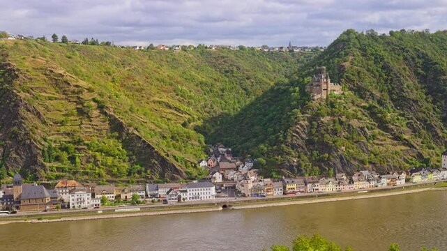 Panorama aerial view over the romantic rural town of Sankt Goarshausen, with steep cliffs and natural landscape on a sunny day, Rhine Valley, Germany