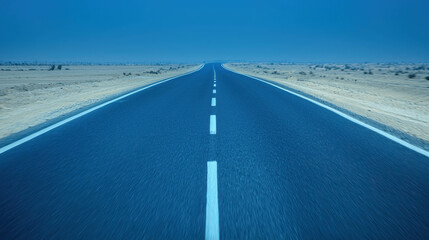 Fototapeta premium Vast Desert Road Stretching Into Blue Horizon Under Clear Sky in Evening Light
