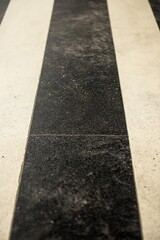 Symmetric Black and White Concrete Floor with Striped Design