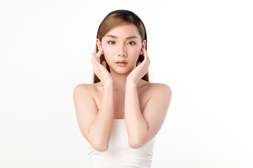 Fototapeta premium A beautiful young Asian woman with clean, fresh skin against a white background. She represents beauty, skincare, and spa treatments.