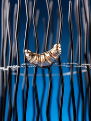 Close up of  golden  croissant brooch on white background