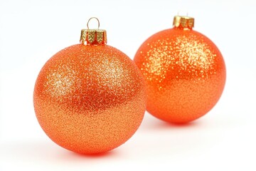 Two orange glitter Christmas baubles. Perfect for holiday cards, festive decorations, and winter themes.