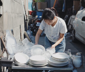 Washing dishes urban alley daily life outdoor candid hard work and community efforts