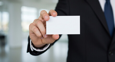 high-quality image features a professional businessman&rsquo;s hand presenting a blank white business card in close-up