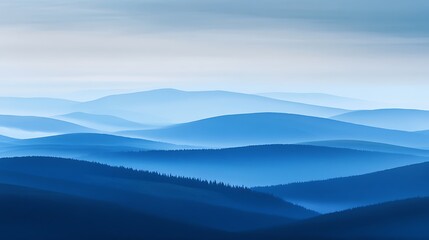 Obraz premium Serene blue mountain range landscape with fog.