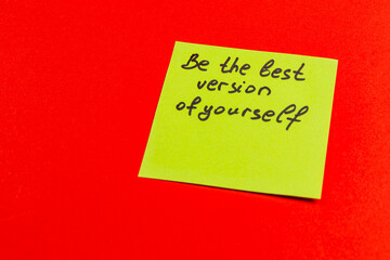 Motivational sticky note with inspiring message on a vibrant red background