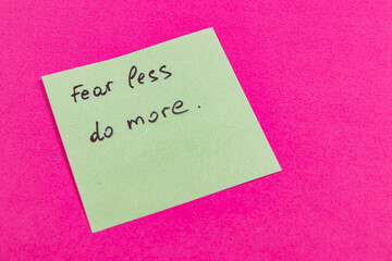 Motivational note on a sticky pad promoting action and courage in daily life