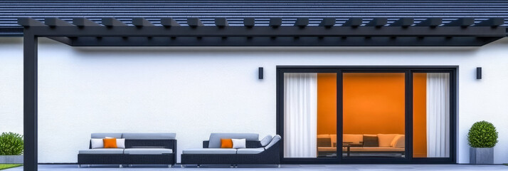 Modern outdoor seating area with stylish furniture and bright interior lights at dusk