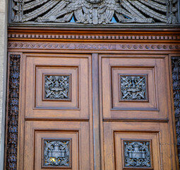 Elegant wooden door showing intricate carvings and metalwork from 1807