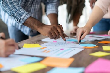 Close Up Of Diverse Hands Collaboratively Working On A Project Using Colorful Sticky Notes And Documents On A Wooden Table Perfect For Teamwork And Collaboration Concepts.Related to brainstorming