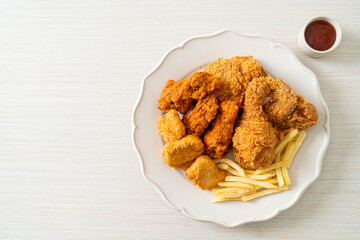 fried chicken with french fries and nuggets on plate