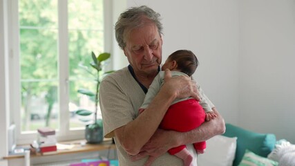 Grandfather gently cradling his infant grandchild, both sharing a tender moment of closeness and comfort in a bright, serene living room, emphasizing the bond between generations