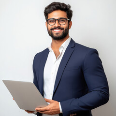 Young handsome indian businessman in suit holding laptop