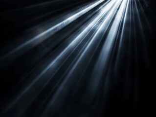 A black and white photo of a light beam of light shining through a dark room