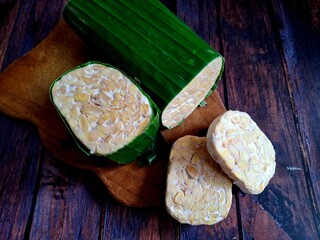 cutting tempeh on wooden background