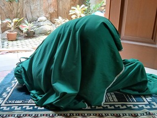 Muslim woman praying individually at home