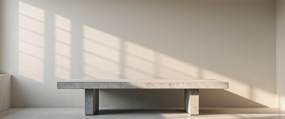 Concrete table with soft shadows on wall from window light neutral tones Copy Space.