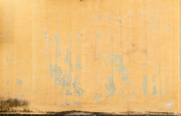 Fototapeta premium Textured Yellow Wall with Peeling Paint, Aged Building Facade