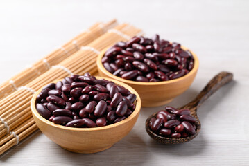Red kidney beans in wooden bowl and spoon on white background, Food ingredient