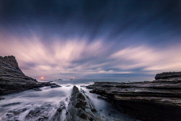 Sunset with a sky with dramatic clouds on the beach of Tunelboca on the cliffs of La Galea, Getxo, Bizkaia